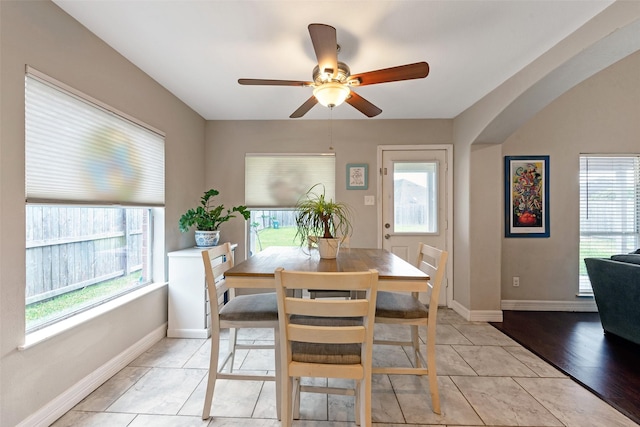 tiled dining area with ceiling fan