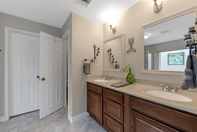 bathroom with vanity and a shower with door