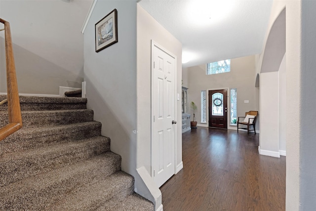 entrance foyer with dark hardwood / wood-style floors and a high ceiling