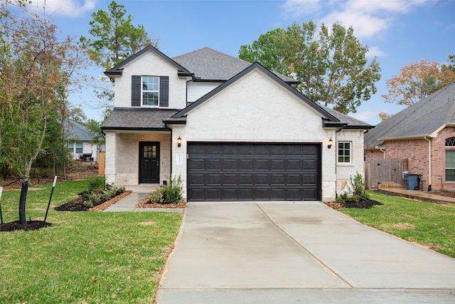 view of front of home with a garage and a front yard