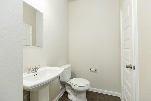 bathroom featuring sink, hardwood / wood-style floors, and toilet