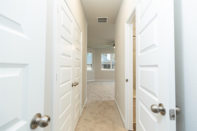 hallway featuring light carpet