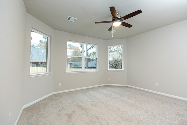 empty room featuring light colored carpet and ceiling fan