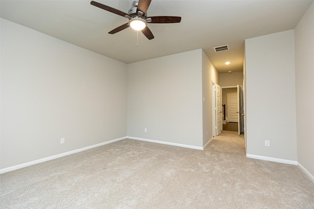 carpeted spare room featuring ceiling fan