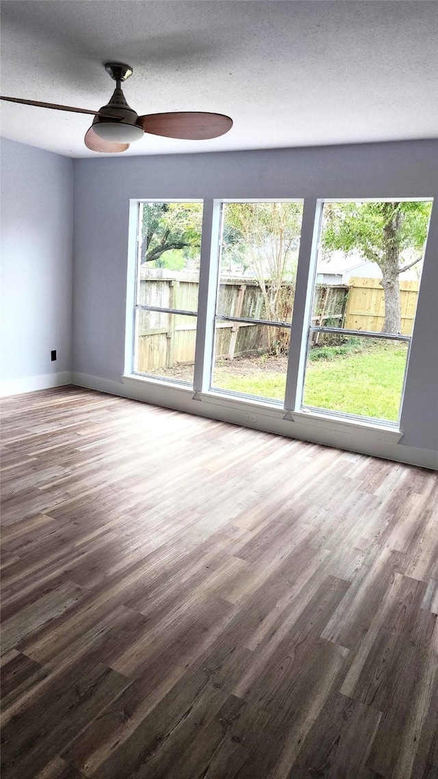 spare room featuring hardwood / wood-style flooring, a textured ceiling, and ceiling fan