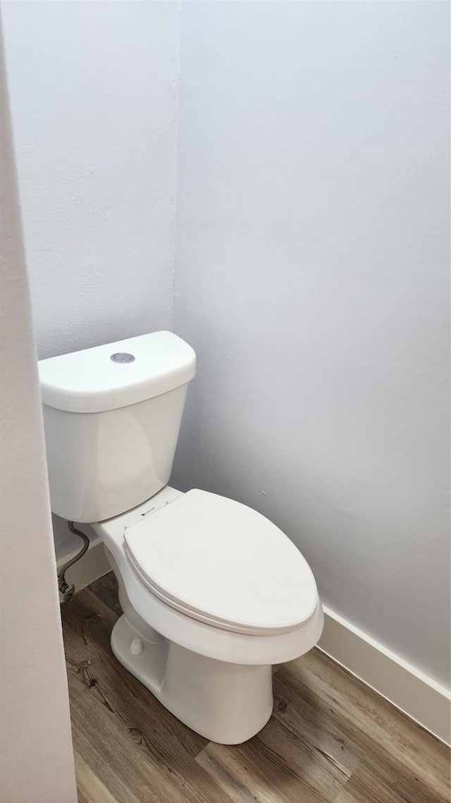 bathroom with wood-type flooring and toilet