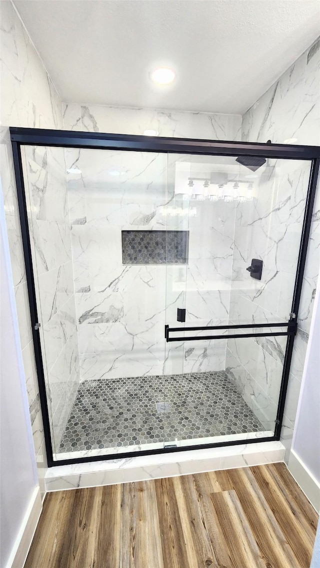 bathroom with a shower with shower door