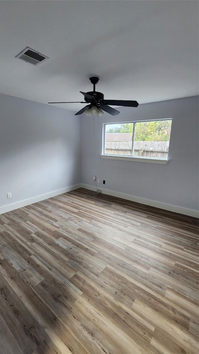 empty room featuring ceiling fan and light hardwood / wood-style flooring