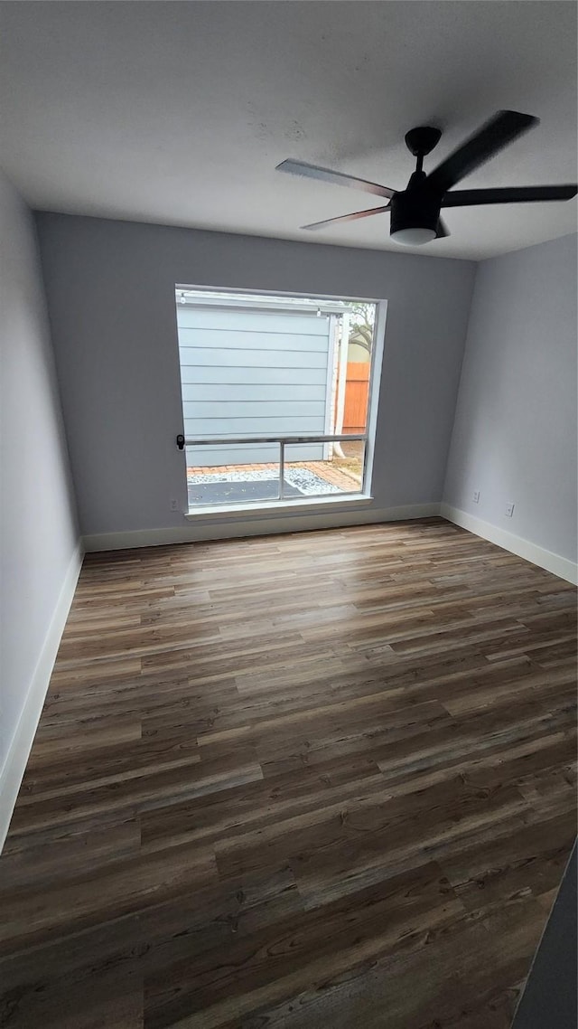 empty room with ceiling fan and dark hardwood / wood-style floors