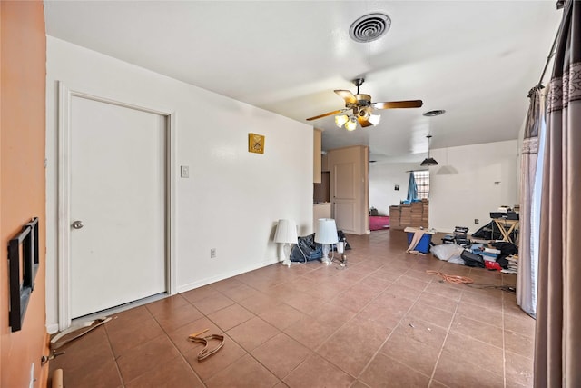 tiled living room featuring ceiling fan