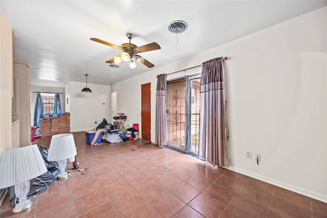 interior space featuring tile patterned flooring and ceiling fan