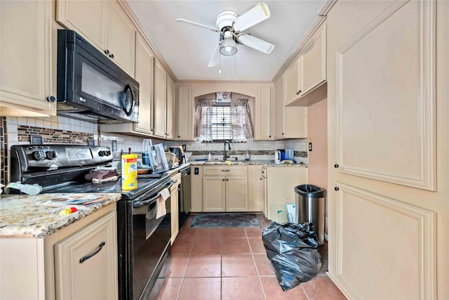 kitchen with sink, backsplash, black appliances, cream cabinets, and tile patterned floors