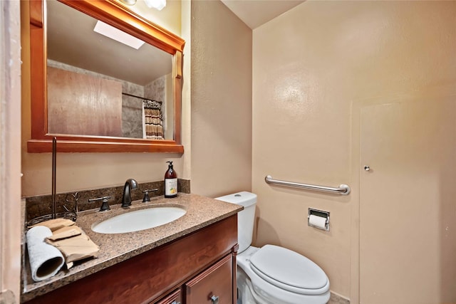 bathroom featuring vanity, toilet, and a shower with shower curtain