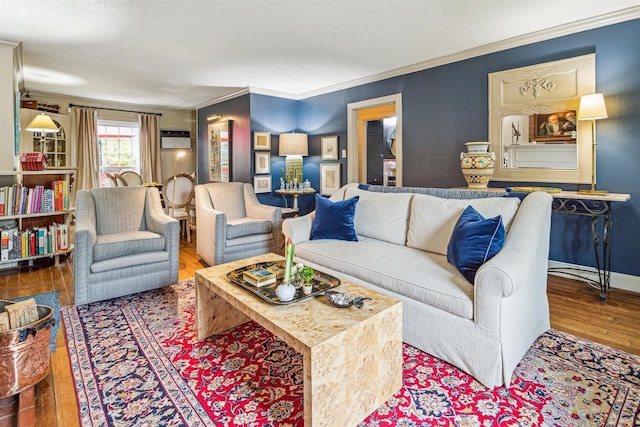 living room featuring crown molding, wood-type flooring, and a wall mounted AC