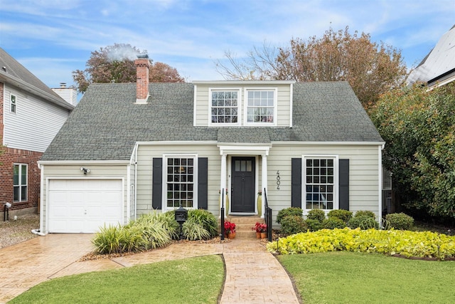 view of front of property featuring a garage and a front lawn