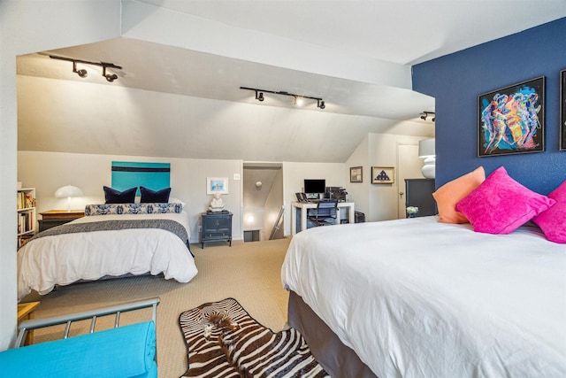 bedroom featuring lofted ceiling, rail lighting, and carpet floors