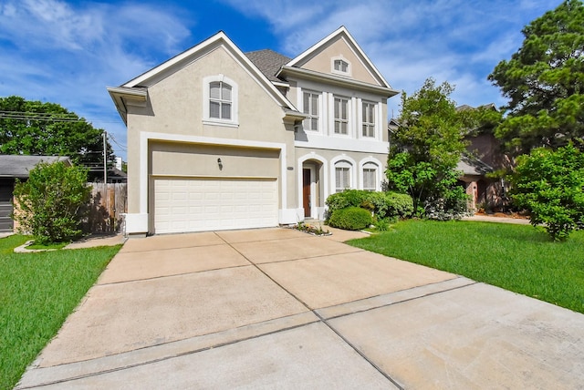 view of front of property featuring a garage and a front yard