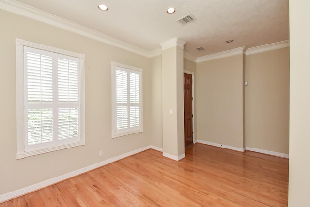 unfurnished room with crown molding and light hardwood / wood-style floors