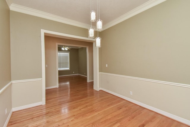 spare room with crown molding and light hardwood / wood-style flooring