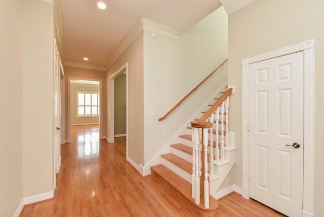 interior space featuring ornamental molding and light hardwood / wood-style floors