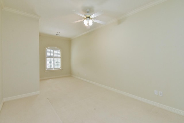 spare room with ornamental molding and ceiling fan