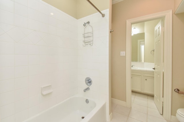 full bathroom featuring tiled shower / bath, vanity, tile patterned floors, and toilet