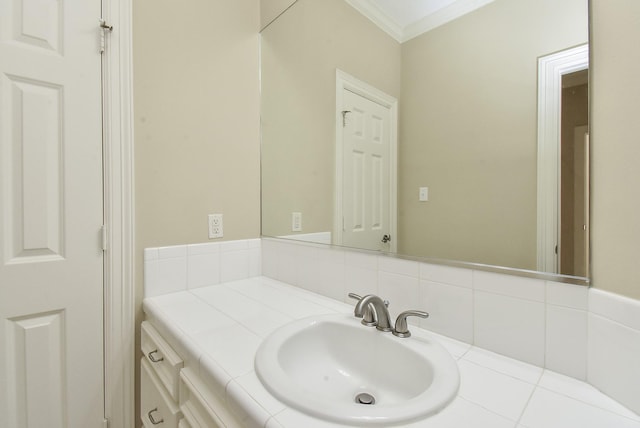 bathroom with tasteful backsplash, crown molding, and vanity