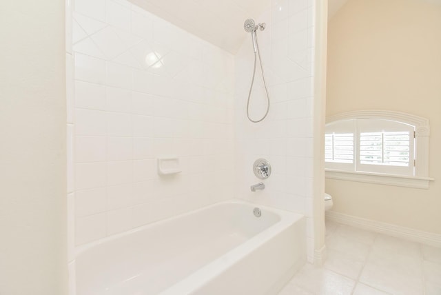 bathroom with tile patterned floors, toilet, and tiled shower / bath combo