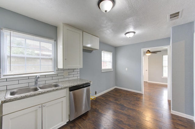 kitchen featuring dark wood finished floors, visible vents, a sink, and stainless steel dishwasher