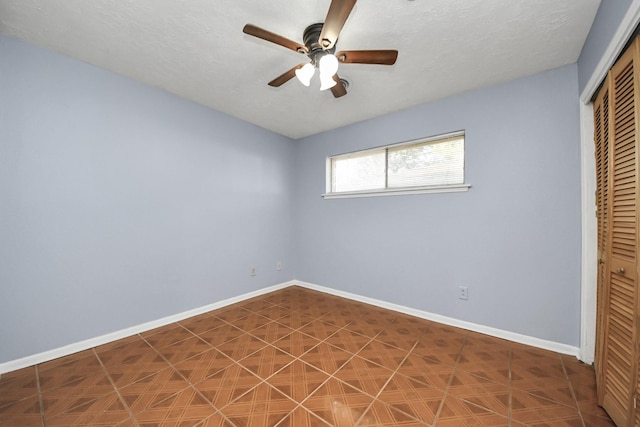 unfurnished bedroom featuring a textured ceiling, ceiling fan, and a closet