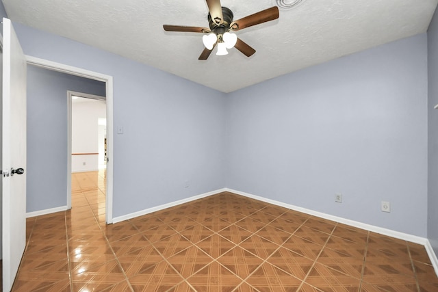 spare room with ceiling fan and a textured ceiling