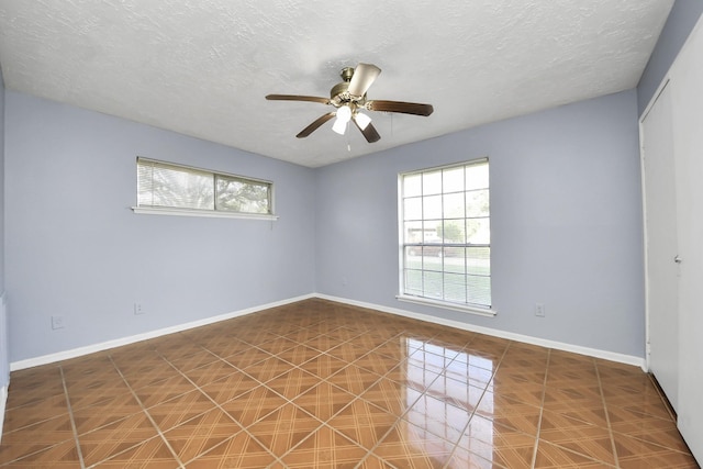 spare room featuring ceiling fan and a textured ceiling