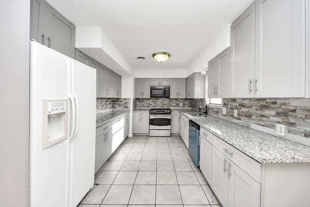 kitchen with light tile patterned flooring, appliances with stainless steel finishes, sink, gray cabinetry, and backsplash