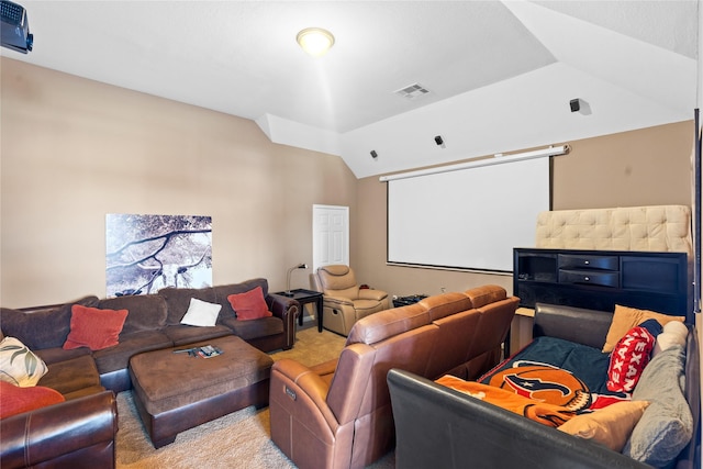 home theater featuring vaulted ceiling and light carpet