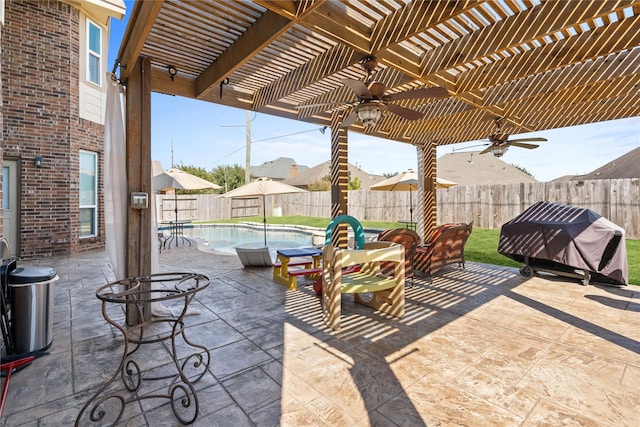 view of patio featuring a fenced in pool, area for grilling, ceiling fan, and a pergola