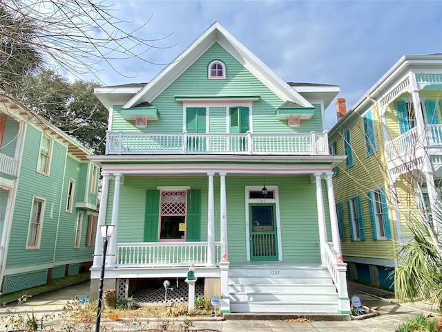 view of front of property with a porch and a balcony