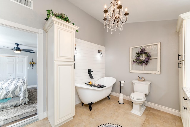 bathroom with lofted ceiling, tile patterned flooring, a bath, ceiling fan with notable chandelier, and toilet