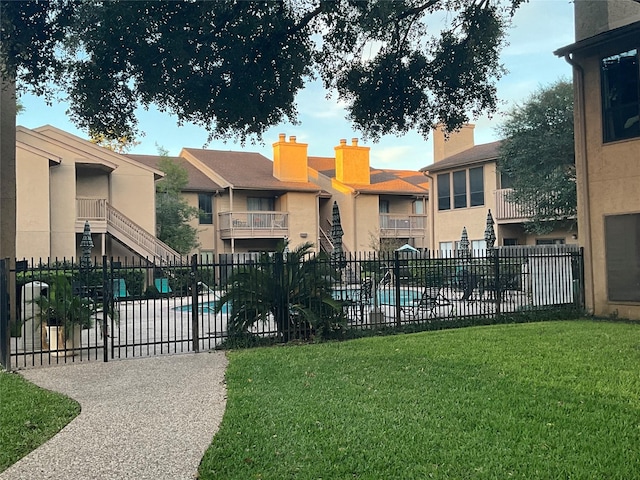 view of pool with a yard