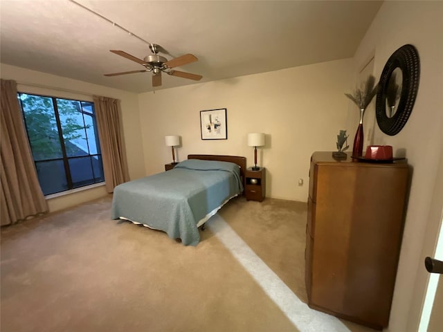 bedroom with ceiling fan and light carpet