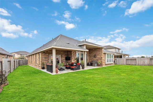 back of property with an outdoor living space, a patio, and a yard