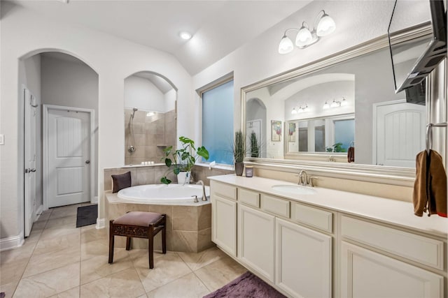 bathroom featuring vanity and separate shower and tub