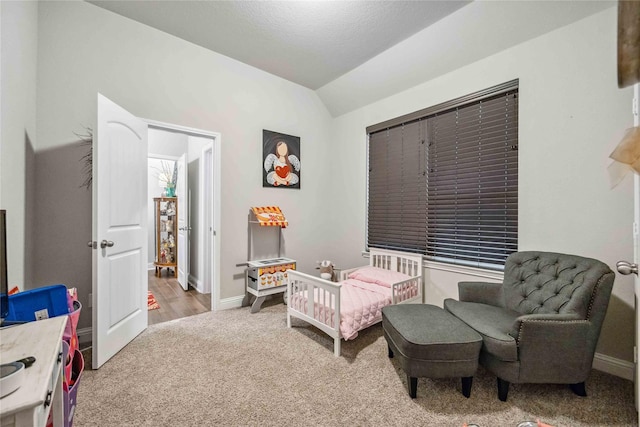 bedroom with lofted ceiling and light colored carpet