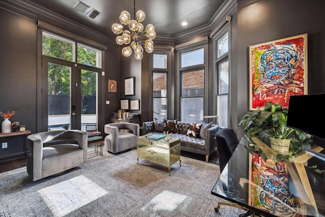 living room with an inviting chandelier, crown molding, and french doors