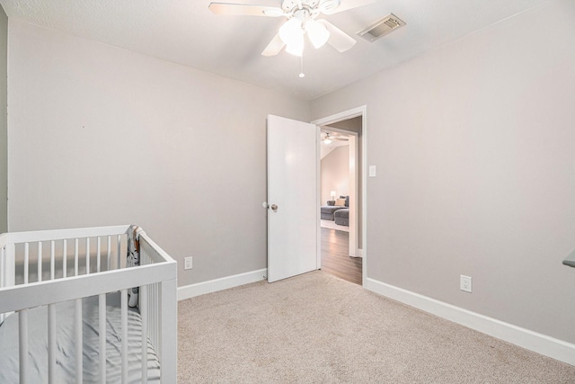 bedroom featuring ceiling fan and light colored carpet