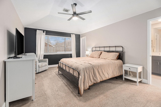 carpeted bedroom featuring lofted ceiling, ceiling fan, and ensuite bathroom