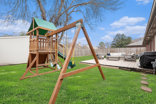 view of play area featuring a wooden deck, a yard, and outdoor lounge area