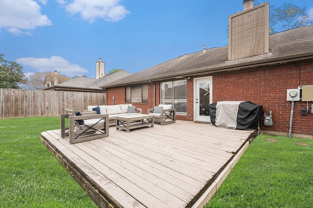 wooden terrace featuring area for grilling, a yard, and outdoor lounge area