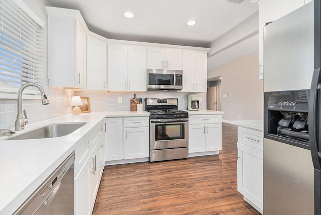 kitchen featuring white cabinetry, stainless steel appliances, dark hardwood / wood-style floors, and sink