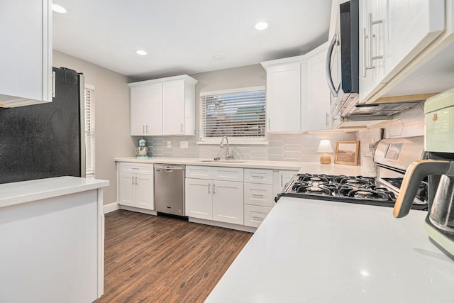 kitchen featuring white cabinetry, stainless steel appliances, dark hardwood / wood-style floors, and sink