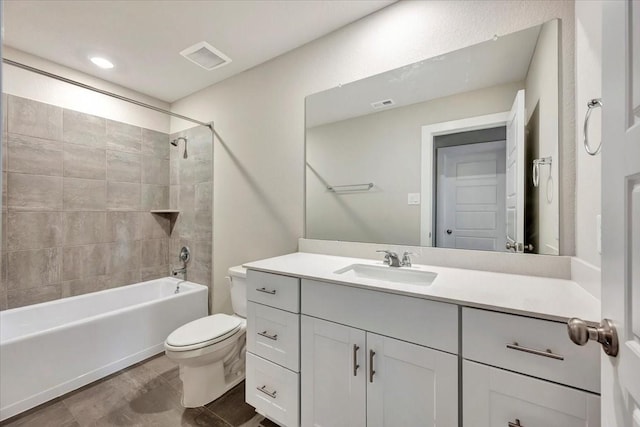 full bathroom featuring vanity, toilet, and tiled shower / bath combo